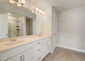 Thumbnail 13 of 16 - a bathroom with a large mirror and two sinks