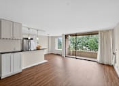 Thumbnail 1 of 66 - A kitchen with wooden floors and white cabinets.
