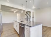 Thumbnail 4 of 20 - a kitchen with an island and stainless steel appliances