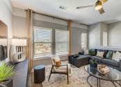 Thumbnail 14 of 56 - a living room with gray walls and a large window