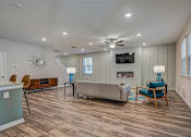 Thumbnail 6 of 21 - a living room with a couch chairs and a fireplace