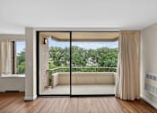 Thumbnail 2 of 66 - A room with a sliding glass door leading to a balcony.