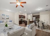 Thumbnail 7 of 28 - Omnia at Richmond Hill Townhomes in Georgia photo of a living room and kitchen.
