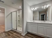 Thumbnail 14 of 21 - a bathroom with a large mirror and a walk in shower