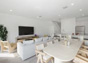 Thumbnail 4 of 23 - a living room and dining room with a table and chairs