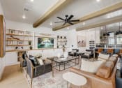 Thumbnail 32 of 56 - a living room with furniture and a ceiling fan