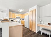 Thumbnail 5 of 47 - A kitchen with white appliances and wooden cabinets.