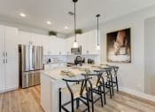 Thumbnail 2 of 56 - a kitchen with white cabinets and a stainless steel refrigerator