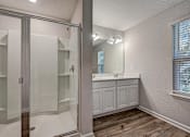 Thumbnail 13 of 21 - a bathroom with a shower and a sink