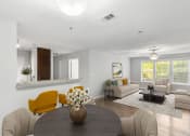 Thumbnail 7 of 12 - One K Apartments in Atlanta, GA photo of a living room and dining room with a table and chairs