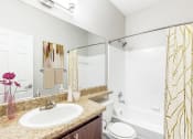 Thumbnail 8 of 12 - One K Apartments in Atlanta, GA photo of a bathroom with a sink and a shower and a toilet