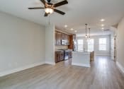 Thumbnail 10 of 25 - an open kitchen and living room with a ceiling fan