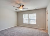 Thumbnail 6 of 25 - 3-BR Homes In North Charleston, SC - Sumner Village - Spacious Bedroom With Carpet Flooring, Ceiling Fan, Large Window, And Access To The Bathroom