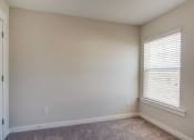 Thumbnail 21 of 25 - an empty room with a window and a door