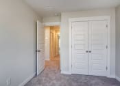 Thumbnail 20 of 25 - a bedroom with two closets and a hallway leading to a closet
