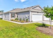 Thumbnail 2 of 62 - a blue house with a garage and a lawn