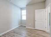 Thumbnail 11 of 62 - an empty room with a white door and a window