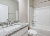 Thumbnail 12 of 62 - a bathroom with a sink and a toilet and a shower