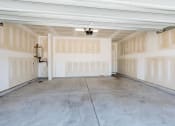 Thumbnail 58 of 62 - the inside of a garage with white walls and a concrete floor