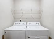 Thumbnail 57 of 62 - a washer and dryer in a laundry room with a shelf on the wall
