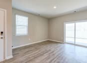 Thumbnail 55 of 62 - an empty living room with wood floors and a glass door