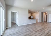 Thumbnail 51 of 62 - the living room and kitchen of a new home with white walls and wood flooring