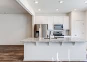 Thumbnail 3 of 45 - a kitchen with white cabinets and a granite counter top