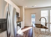 Thumbnail 4 of 45 - Townhomes Near The Citadel - Highland Townhomes - Kitchen With Stainless Steel Appliances, Granite Countertops, Plenty Of Storage, Pantry, And Kitchen Island
