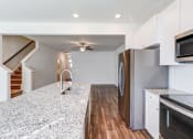 Thumbnail 44 of 45 - a kitchen with granite counter tops and stainless steel appliances