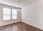 Thumbnail 40 of 45 - an empty living room with wood flooring and a window