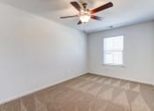 Thumbnail 25 of 45 - an empty room with a ceiling fan and a window