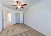 Thumbnail 24 of 45 - a living room with carpet and a ceiling fan