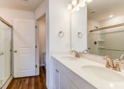 Thumbnail 32 of 45 - a bathroom with two sinks and a shower