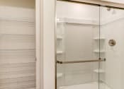 Thumbnail 31 of 45 - a shower with a glass door in a bathroom