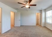 Thumbnail 15 of 45 - an empty living room with a ceiling fan and window