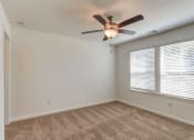 Thumbnail 11 of 45 - an empty room with a ceiling fan and a window