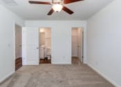 Thumbnail 8 of 45 - Townhouses For Rent In North Charleston, SC - Highland Townhomes - Spacious Bedroom With Plush Carpeting, Ceiling Fan, Walk-In Closet, And Bathroom