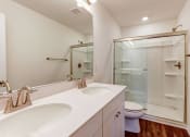 Thumbnail 18 of 45 - a bathroom with two sinks and a shower and a toilet