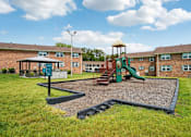Thumbnail 4 of 40 - On-site children’s playground with slides and swings at Reserve at Drakes Creek Apartments