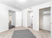 Thumbnail 11 of 20 - a renovated living room with white walls and a rug