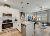 Thumbnail 6 of 56 - a kitchen with white cabinets and stainless steel appliances