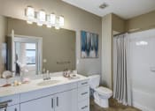Thumbnail 12 of 46 - bathroom with white vanity and tub shower
