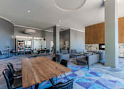 Thumbnail 15 of 24 - A modern dining room with a wooden table and chairs.