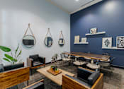 Thumbnail 16 of 24 - A room with a blue wall and a wooden table with chairs.