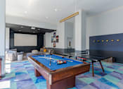 Thumbnail 14 of 24 - A pool table is in the middle of a room with a blue carpet.