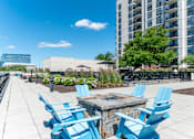 Thumbnail 24 of 24 - A patio with blue chairs and a table.