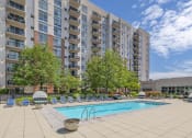 Thumbnail 34 of 46 - a swimming pool in front of an apartment building