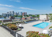 Thumbnail 35 of 46 - a swimming pool at a hotel with a city in the background
