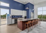 Thumbnail 22 of 46 - a kitchen with a counter and chairs in front of a large window