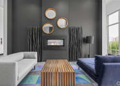 Thumbnail 25 of 46 - a living room with couches a coffee table and a fireplace